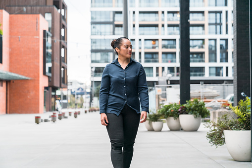 Beautiful woman in casual clothing enjoying a walk out in the city, Pacific Islander woman.