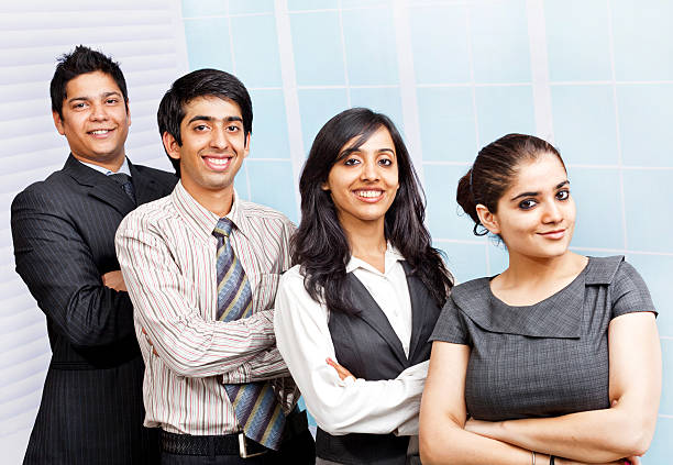 vier zuversichtlich junge freudig indische business team person personen - horizontal female with group of males posing looking at camera stock-fotos und bilder