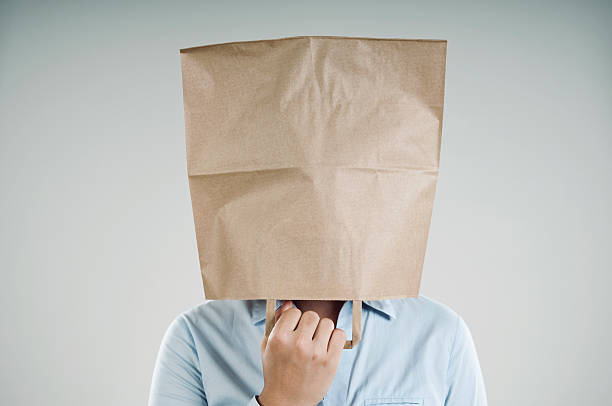 paper bag woman wearing a paper bag embarrassment unrecognizable person wearing a paper bag human head stock pictures, royalty-free photos & images