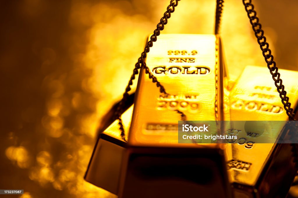 Gold ingot on weight scale http://www.gunaymutlu.com/iStock/GOLD_Banner.jpg Ingot Stock Photo
