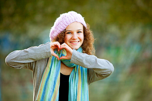 istock smiling teenager making heart shape 173237590