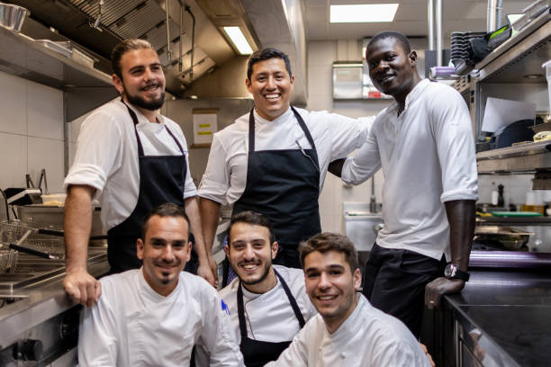 istock Multi ethnic cooking team posing for a team photo in the kitchen at work 1732376844