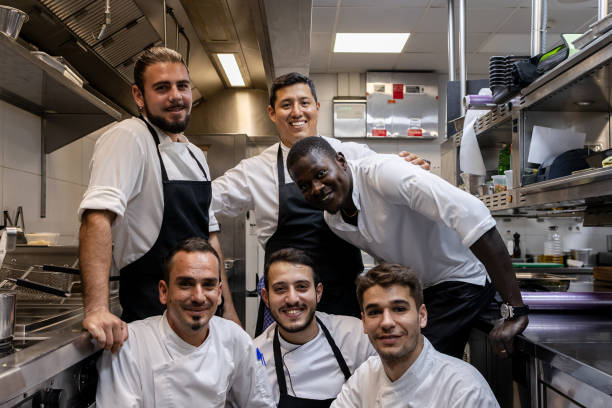 istock Multi ethnic cooking team looking at the camera while taking a team photo 1732376855