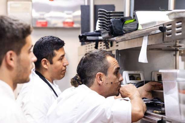 istock Three chefs are in the kitchen looking towards the restaurant while waiting for a command 1732377947