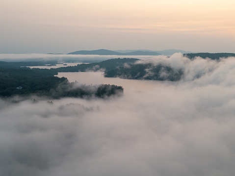 Sunrise aerial of cloud inversion on Little Squam Lake  at sunrise in fall