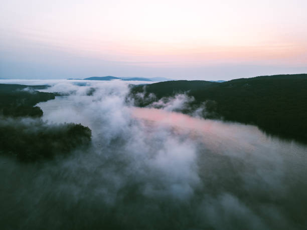istock Drone aerial above cloud inversion on Squam Lake at sunrise 1732389191