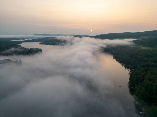 istock Drone aerial above cloud inversion on Squam Lake at sunrise 1732389193