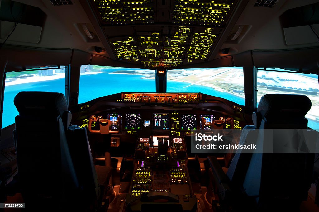 An interior shot of the cockpit Cockpit. inside a plane.plane fly over the sea. Cockpit Stock Photo