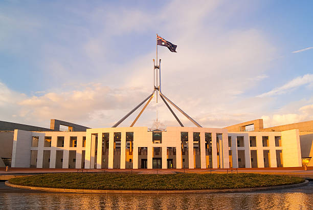Canberra - Parliament House (Sunrise) The rising sun casts a golden sheen on Parliament House in Canberra, Australia. canberra stock pictures, royalty-free photos & images