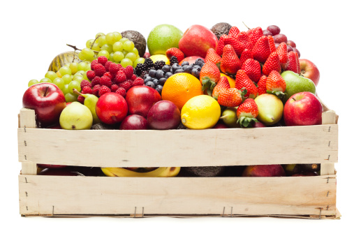Wooden box full of fruits on white background