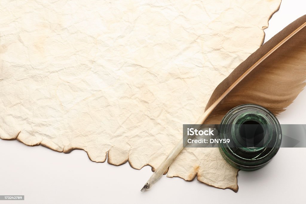 Quill and Inkwell on top of old blank document A quill and inkwell sitting on an old blank document. Quill Pen Stock Photo