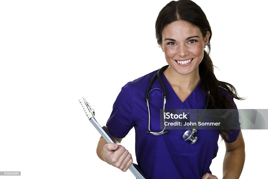 Nurse holding a clipboard Cheerful nurse or doctor wearing scrubs, holding a medical clipboard and isolated on white background  Female Nurse Stock Photo