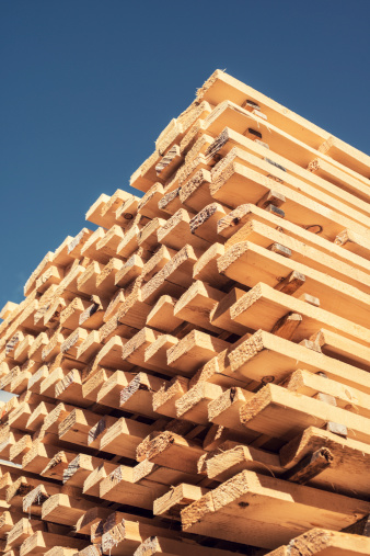 Spruce lumber is stacked to dry in a lumber yard.