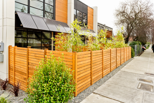 Photo of a modern home exterior with solar panel awnings.