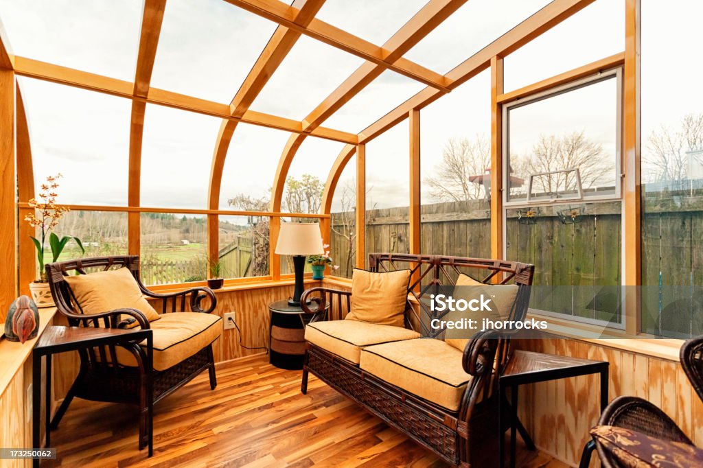Small Cozy Solarium Photo of a small furnished natural wood sun room (solarium). Tanning Bed Stock Photo