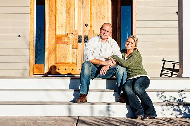 istock Young Couple Sitting on Front Steps of Their Home 173250236