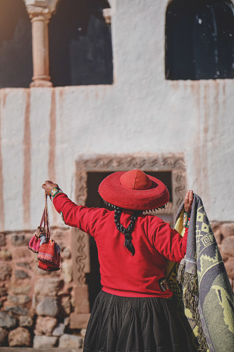 Peruvian woman selling souvenirs at Inca ruins, Sacred Valley, Peru
