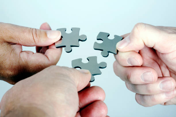 istock Three Persons with Puzzle in Hand Coming Together 173250266