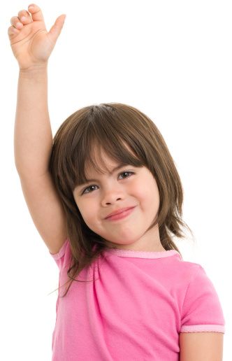 I don't know. Portrait of ambiguous little girl wearing striped T-shirt shrugging shoulders with no idea gesture, clueless embarrassed face. Indoor studio shot isolated on gray background.