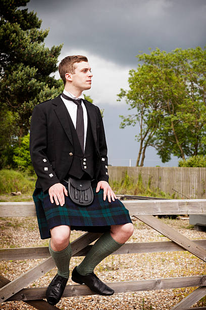 istock Scotsman sitting on a gate outdoors 173251003