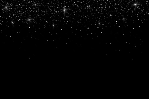Glittering stardust on black background