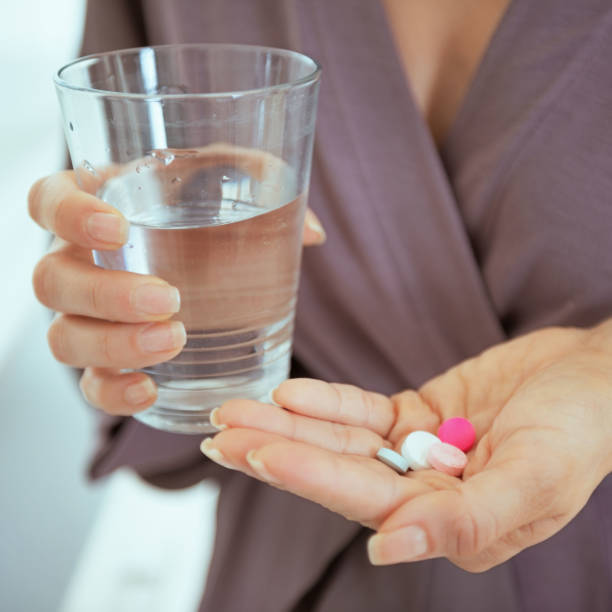 istock Closeup on young woman with pills 1732521540