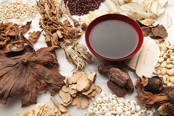 Display of Chinese Herbal Medicine Ingredients and the Tonic Hz Subject: A variety of Chinese herbal medicine ingredients and the resulting tonic tea displayed on a marble board. chinese herbal medicine stock pictures, royalty-free photos & images