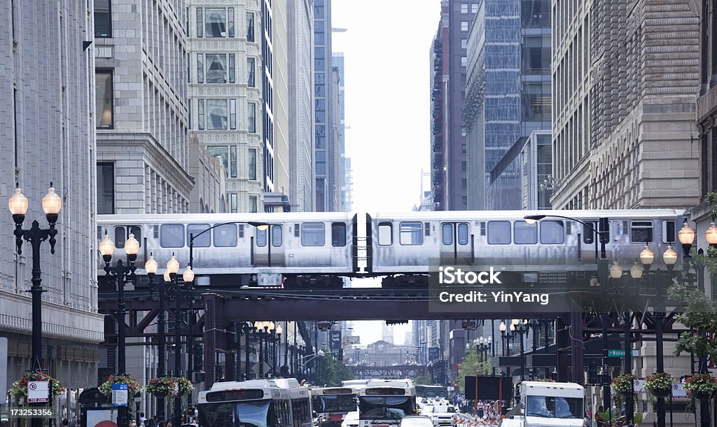 The Loop and El Train in Chicago Downtown Subject: Downtown street of Chicago, the retail and financial center with the el train crossing above the street. Chicago - Illinois Stock Photo