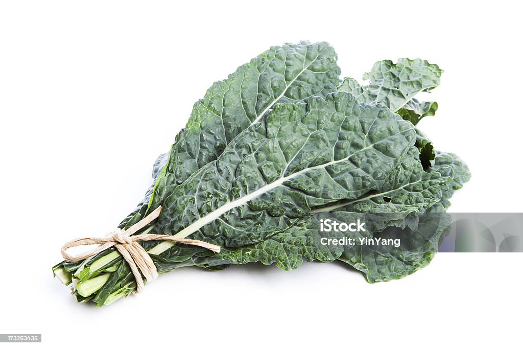 Lacinato Kale, Raw Green Vegetable Tied Bunch, Isolated on White A bouquet of Lacinato kale, a raw, fresh, leafy green vegetable, tied as a stack together in a bunch and isolated on white background. The food may be an ingredient in vegetarian meals and may be grown in an organic garden. It is part of a diet for healthy eating. Kale Stock Photo
