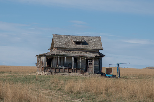 Old run down and abandoned ranch house on the Montana prairie in western USA of North America. Nearest cities are Bozeman and Billings Montana.