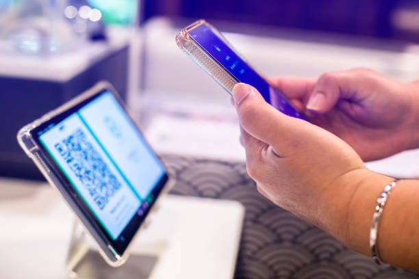 istock hand holding smart phone and simulate scan QR code over smart device for registration in to seminar or meeting. The concept of electronic registration. 1732561956