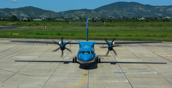 Dalat, Vietnam - Oct 30, 2015. An ATR 72 airplane of Vietnam Airlines docking at Lien Khuong Airport (DLI) in Dalat, Vietnam.