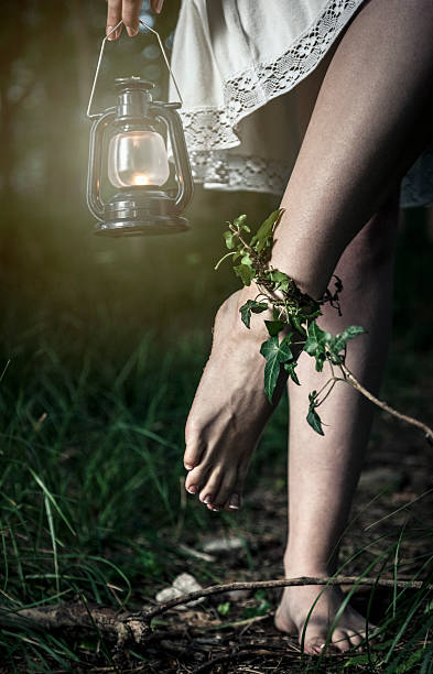 istock Barefoot woman with lantern trapped in the forest 173259633
