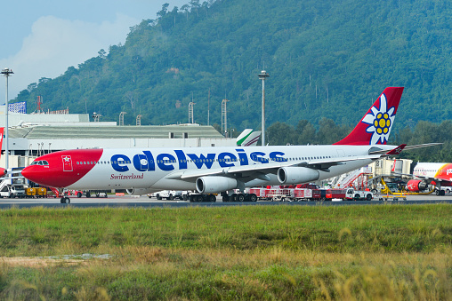 Phuket, Thailand - Apr 25, 2018. An Airbus A340-300 airplane of Edelweiss Air taxiing on runway of Phuket Airport (HKT).