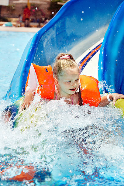 istock Child on water slide at aquapark. 173260547