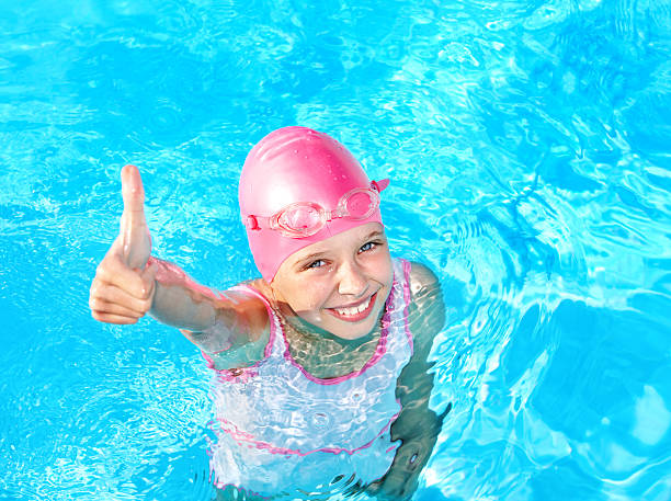 Child swimming in pool. stock photo