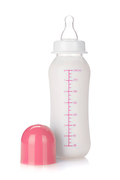 Baby bottle with milk for girl. Isolated on white background