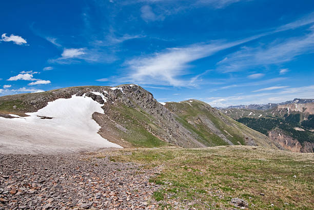Snowfield at Columbine Lake Pass The San Juans in southern Colorado are a high altitude range of mountains that straddle the Continental Divide. This wide-open landscape, at 12,000, is well above timberline. The photograph was taken from Columbine Lake Pass in the San Juan National Forest near Silverton, Colorado, USA. jeff goulden san juan mountains stock pictures, royalty-free photos & images