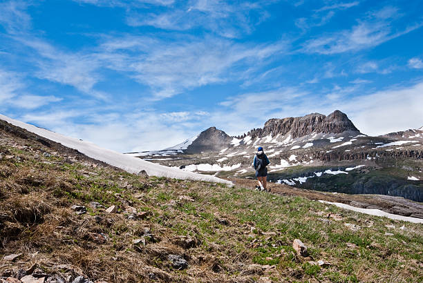Hiker Crossing Columbine Lake Pass The San Juans in southern Colorado are a high altitude range of mountains that straddle the Continental Divide. This wide-open landscape, at 12,000, is well above timberline. The photograph was taken from Columbine Lake Pass in the San Juan National Forest near Silverton, Colorado, USA. jeff goulden san juan mountains stock pictures, royalty-free photos & images