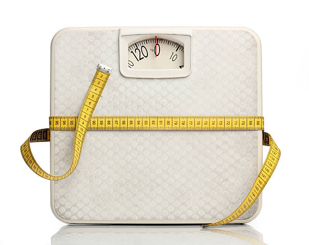 istock Weight scale with a measuring tape over white 173268967