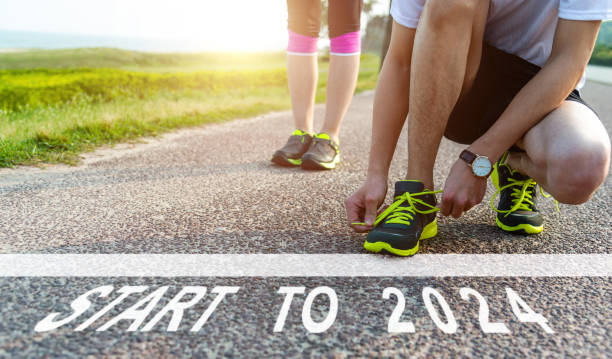 istock Start to 2024 and white starting line on asphalt road 1732697524
