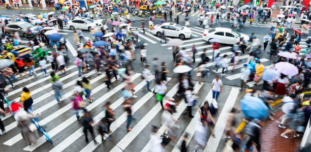 istock Motion blurred people and cars on the sidewalk 1732701177