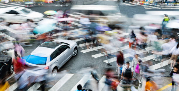 istock Motion blurred people and cars on the sidewalk 1732701215