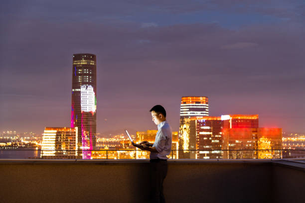 istock Businessman standing on the rooftop and using laptop 1732702785