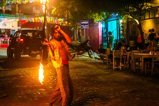 Sayulita, Nayarit Mexico, October 25 2023 street artist juggling fire with tourists on the streets of sayulita, nayarit