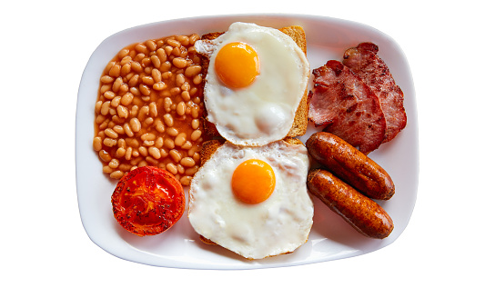 Breakfast bread, fried eggs, ham, sausage placed on white background, food