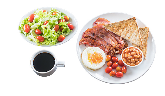 Breakfast food, fried eggs, ham, bread, coffee, salad placed on white background
