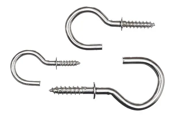 Photo of three size of metallic hook screws isolated on