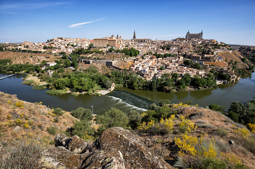 City view of Toledo on the Tagus River, Spain with the Cathedral and Alcazar at the background.