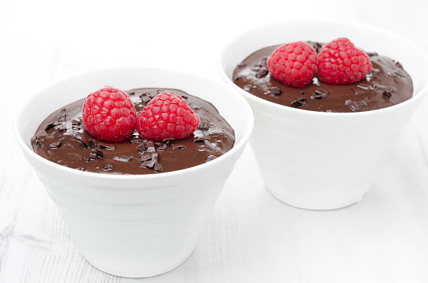 istock two bowls of chocolate mousse and raspberry on the white 173274687